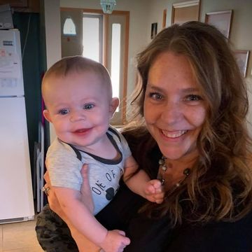 Julie holding her grandson, Aiden